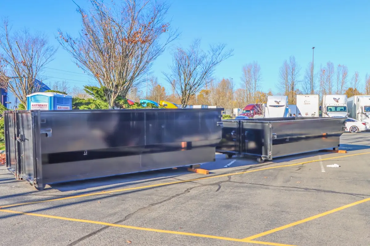 Professional dumpster rental service with roll-off container on residential driveway in Manlius